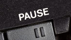 Macro close up photograph of vintage tape machine play and record pause button.