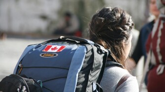 canadian tourist traveller with backpack rucksack napsack in city town