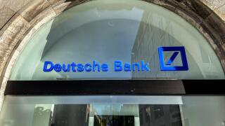 Deutsche Bank logo on the window of a branch in Munich