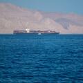 Bukha, OMAN - MAY 28 2021: Iranian coastline near the Strait of Hormuz. giant sea container ship in the strait of Hormuz. Near East