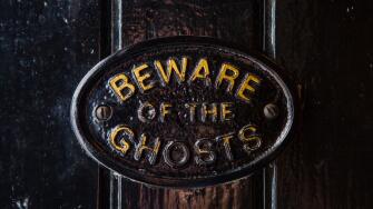 A Beware of the Ghosts plaque on the entrance to the Golden Fleece public house in York, England. It is regarded to be the most
