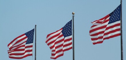 Stars and Stripes flags flying on three flagpoles United States of America USA