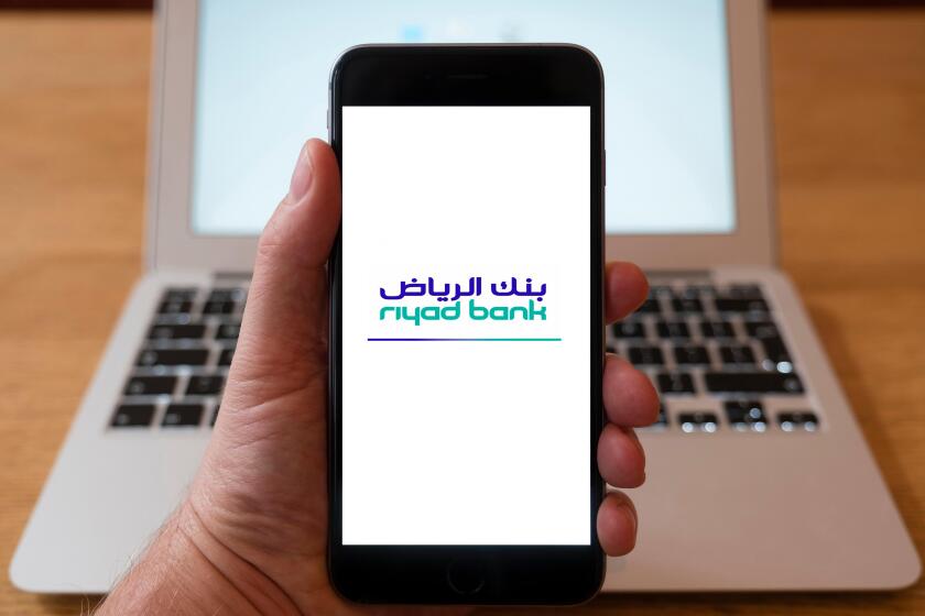 Using iPhone smart phone to display website logo of Riyad Bank from Saudi Arabia