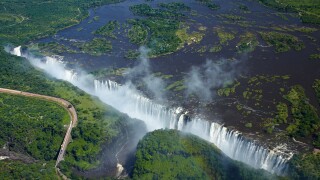 Victoria Falls or "Mosi-oa-Tunya" (The Smoke that Thunders), Zambezi River, and Victoria Falls Bridge, Zimbabwe / Zambia border