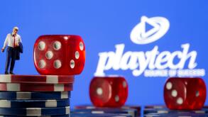 Businessman toy figure is placed on gambling chips in front of displayed Playtech logo in this illustration taken, November 8, 2021. REUTERS/Dado Ruvic/Illustration