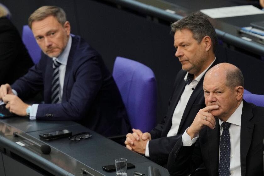 FILE - From right, German Chancellor Olaf Scholz, Economy and Climate Minister Robert Habeck and Finance Minister Christian Lindner listen to a debate about Germany's budget crisis at the parliament Bundestag in Berlin, Germany, Nov. 28, 2023. (AP Photo/M