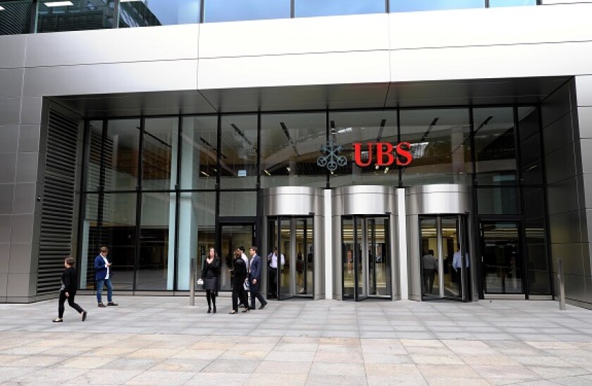 Office workers at the entrance to 5 Broadgate UBS headquarters sign financial building designed by "Make Architects" City of London UK KATHY DEWITT