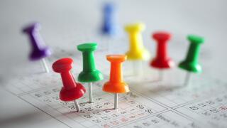 Thumbtack in calendar concept for busy, appointment and meeting reminder