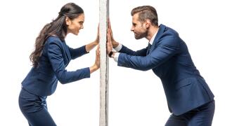 angry businessman and businesswoman pushing wall isolated on white