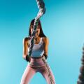 A strong, pumped-up girl in sport leggings throws a battle rope towards the camera. Blue background and empty side ad space.