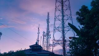 BTS tower pole or radio transmitter towering high into the sky in the morning
