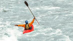 Kayaker having fun in white water rapids,  with copy space