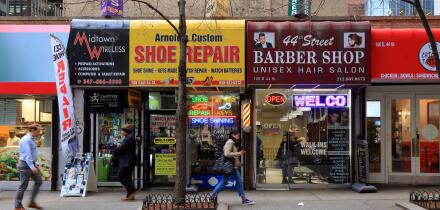Small business storefronts along East 44th St in Midtown Manhattan, New York, NY. essential small business services that office workers may need.