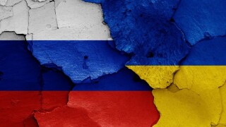 flags of Russia and Ukraine painted on cracked wall