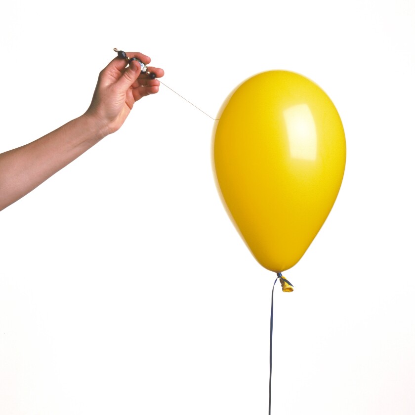 yellow balloon with hand cut out on white background