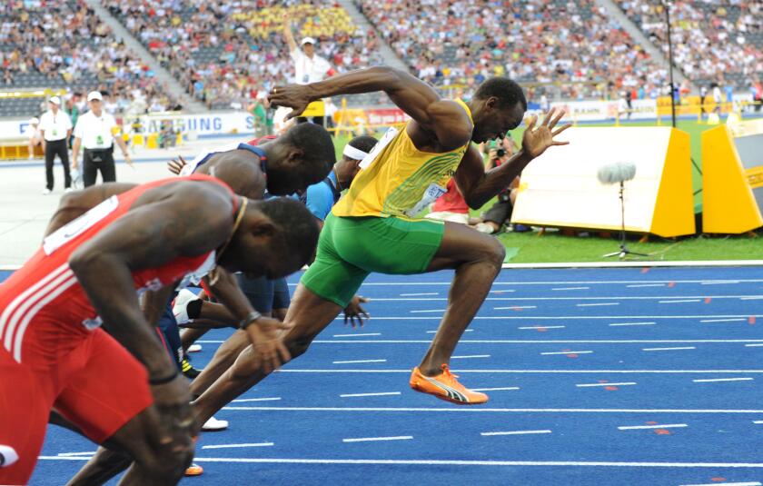 Jamaican Usain Bolt (R) makes a false start at the men?s 100m semi final at the 12th IAAF World Championships in Athletics in Berlin, Germany, 16 August 2009. Photo: HANNIBAL