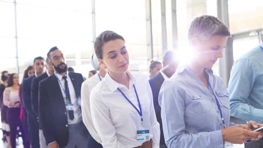 Business people standing in queue in lobby
