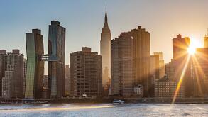 The Sun is shining through a Manhattan buildings in the New York City, US