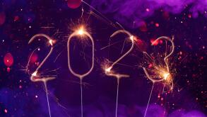 2023 Happy new year Silvester greeting card banner with burning golden sparklers shiny glitter bokeh and colorful smoke