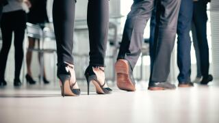 close up. a variety of business people passing through the office business center.