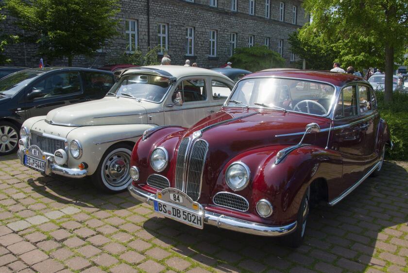 Two vintage cars in red and white parked next to each other in the shade, vintage car, Volvo PV 544, 1964, and BMW 502, 2600 L, 1962, Lower Saxony, Ge