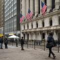 People walk past the New York Stock Exchange (NYSE) on Wall Street on March 4, 2026 in New York.
