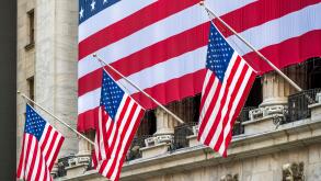 The facade of New York Stock Exchange (NYSE) building adorned with the US flags, Wall Street, Lower Manhattan, New York, USA