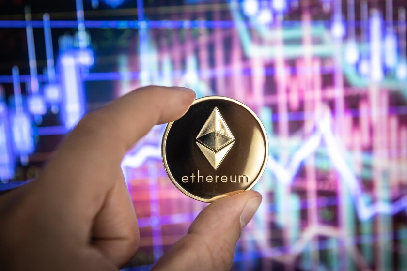 Ethereum cryptocurrency, physical coin in front of colorful char