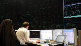 An employee sits in front of a computer screen in the electrical network security center at Amprion GmbH in Cologne, Germany, 29 May 2012. Photo: CAROLINE SEIDEL