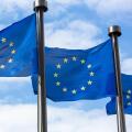 Close up of two European Union Flags flying outside the Berlaymont Building in Brussels, Belgium.