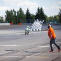 Man holding and waving the checkered flag at the finish of the race