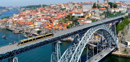 Metro train crossing the Douro River over Dom Luis I Bridge, Porto, Portugal