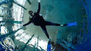Dive training, scuba diver with outstretched arms and legs, balancing, in a swimming pool, Nuremberg, Bavaria, Germany