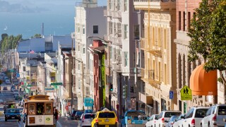 Cable cars on the Powell-Mason track, with the island of Alcatraz in the background, San Francisco, California, USA