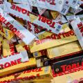 Kiel, Germany - 18. June 2025: Many Toblerone chocolate bars stacked together, creating a mountain of sweet treats