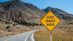 Steep Grades Warning Sign:  A sign warns of a steep climb ahead on a road leading into the Big Horn Mountains of northeastern Wyoming.
