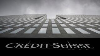 FILE - Grey clouds cover the sky over a building of the Credit Suisse bank in Zurich, Switzerland, Feb. 21, 2022. Swiss regulators have found that Credit Suisse made a ?serious breach? of law in connection with a now-bankrupt firm linked to Australian fin