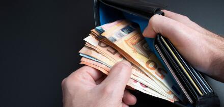 close-up high angle of view of hands of person taking money from purse or wallet