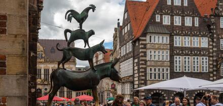Bremen, Germany - July 16, 2022 : many tourist taking a photo at statue of Town Musicians of Bremen