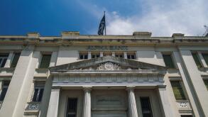 Thessaloniki, Greece Hellenic bank building facade against blue sky. Neoclassical monument of branch of Alpha Bank Greece with sign at Mitropoleos str