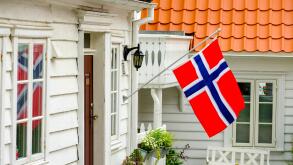 Norwegian flag on white wooden house, Stavanger, Rogaland, Norway