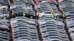 A WORKER WALKS AMONGST BRAND NEW JAGUAR CARS AT THE CAR COMPANYS FACTORY AT CASTLE BROMWICH,BIRMINGHAM ,UK.