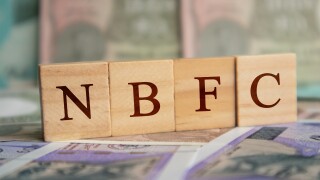 NBFC in wooden block letters on indian currency