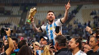 LUSAIL CITY, QATAR - DECEMBER 18: Lionel Messi celebrates with the World Cup Trophy after the FIFA World Cup Qatar 2022 Final match.