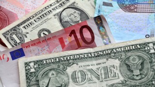 Paper money of American dollars and euro notes.