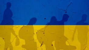 Ukraine,Flag,On,Wall,And,Refugee,Shadows.,Ukraine,War,Concept.