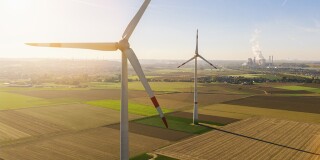 Wind turbine with coal power plant view from drone.jpg