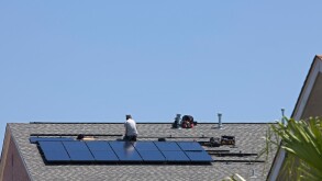 Metairie Louisiana A worker installs a solar hot water system on the roof of a residence