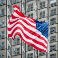 American flag in front of skyscraper.