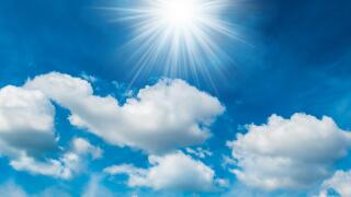 Bright shining sun with white clouds. Image shot 02/2018. Exact date unknown.